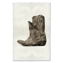 Brown leather boot on a textured white background