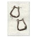 Pair of rustic stirrups on a textured white background