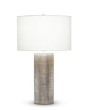 Kelly Table Lamp with textured cylindrical base and white shade on a white background