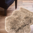 Beige sheepskin fur rug on a wooden floor