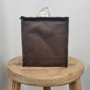 Dark Brown tissue box cover on a wooden stool with a white background