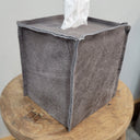 Gray fabric box with a white tissue on a wooden surface
