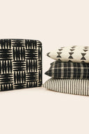 Set of patterned pillows on a white surface.