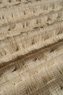 Close-up of textured beige fabric with a subtle pattern
