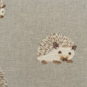 Embroidered hedgehog design on a textured fabric background