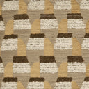 A close-up of a woven textile pattern featuring repeating geometric motifs in beige, cream, mustard yellow, and dark brown.