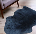 Blue shaggy rug on a wooden floor with a chair partially visible.