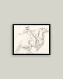 Framed black and white artwork of a horse and rider on a gray wall