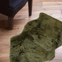 Green fluffy rug on a wooden floor