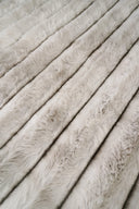 Close-up of beige fur fabric with a soft texture
