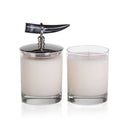 Two glass candles with decorative lids with a real horn on a white background