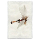 Coachmen fan wing fishing fly on textured white handmade Nepalese paper