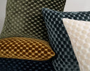 Collection of textured pillows in various colors on a neutral background
