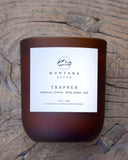 Montana Decor candle labeled 'Trapper' on a wooden surface