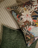 Knubby-Moss green textured pillow styled with a bold floral and tropical print pillow and a striped pillow.