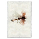 Fly fishing fly on a textured white background