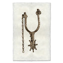 Decorative spur with chain on a textured white background