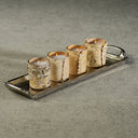 Set of five birch bark candles on a metal tray with a neutral background