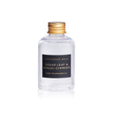 Clear bottle of Cedar Leaf & Hinoki Cypress home fragrance oil with a gold cap on a white background