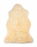 cream sheepskin rug on a white background