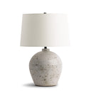 Adam Table lamp with a textured ceramic base and white shade on a white background
