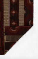 Close-up of a patterned red and brown fabric with geometric designs on a white background