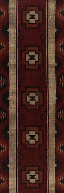 Close-up of a patterned rug with geometric designs in red and beige.