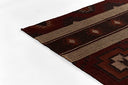 Brown, red and beige patterned rug on a white background
