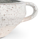 Speckled ceramic bowl with handle on white background