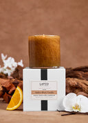 Lafco amber black vanilla candle with packaging on a brown background