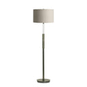 A modern floor lamp with a drum shade in a light beige linen fabric, a clear glass column, a textured sage green middle section, and a dark gray metal base.