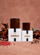 Two Lafco candles with their packaging on a textured brown background.