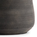 Close-up of a textured black lamp base on a white background