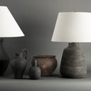 Set of rustic lamps and vases against a gray background