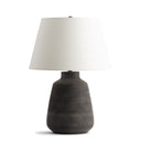 Bruce Table lamp with a textured black base and white shade on a white background