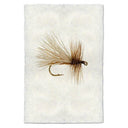 Fly fishing fly on a textured white background