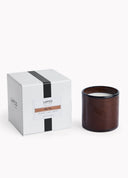 A LAPCO candle in a dark brown wood-grain jar next to its white packaging box with black stripes and a 'Big Sky' scent label, on a clean white background.