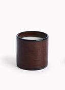 Brown candle in a glass container on a white background