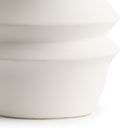 Close-up of a white ceramic lamp base on a white background
