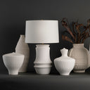 styled White textured lamp and vases on a dark background