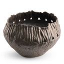 A rustic, handcrafted ceramic bowl with a textured, ribbed exterior and triangular cutouts, shown on a clean white background.