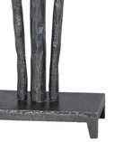 Close-up of a dark metal decorative sculpture or stand with three vertical textured rods on a rectangular base, shown against a plain white background.