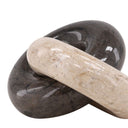 Two stones, one black and one beige, interlocked on a white background