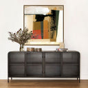 Modern black sideboard with glass doors against a white wall, featuring a abstract painting above.