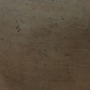 Brown textured surface with specks of dirt or debris