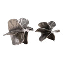 Pair of silver leaf-shaped decorative objects on a white background
