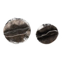 Pair of round silver decorative sculptures on a white background