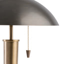 Brass table lamp with a pull chain on a white background
