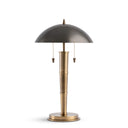 Table lamp with metallic shade and brass base on a white background