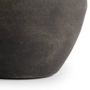 Close-up of a dark brown ceramic pot on a white background
